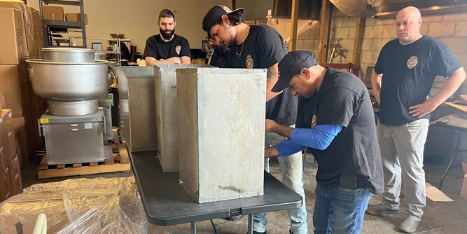 Hands-on training for students learning grease duct inspection and cleaning techniques
